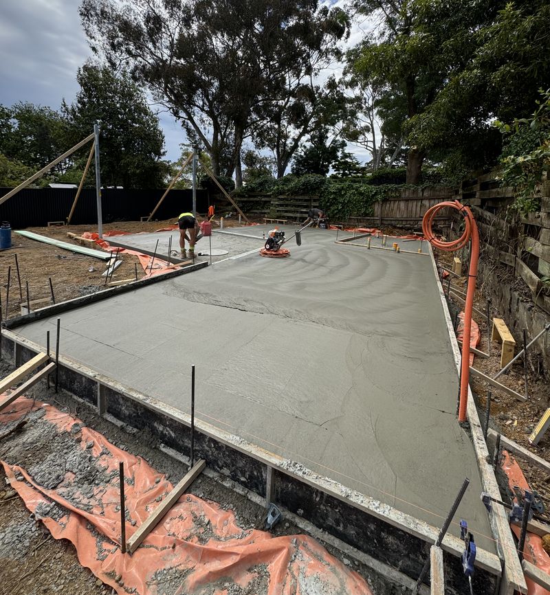 A freshly poured concrete slab within its edge formwork